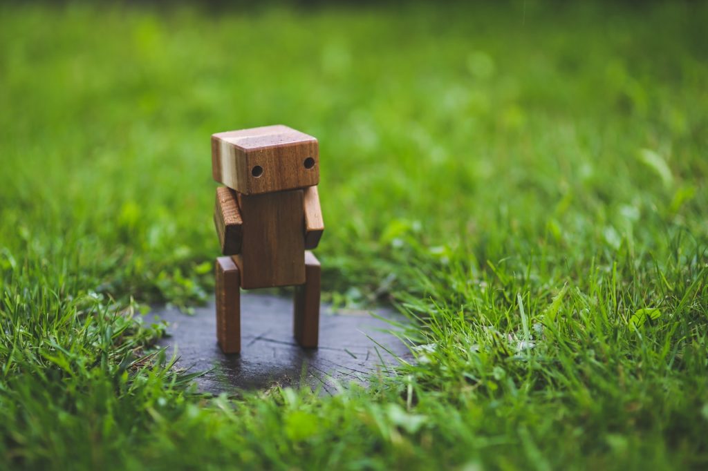 wooden robot in the grass