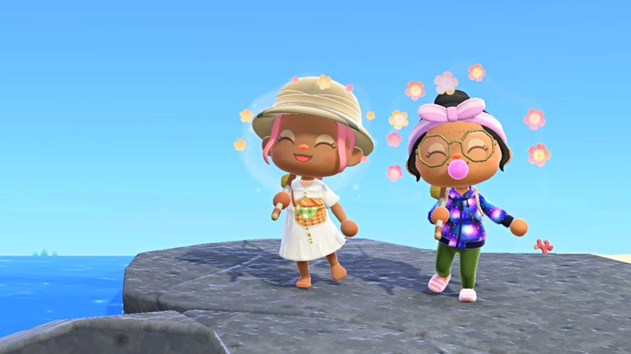 2 BIPOC ACNH characters smiling together on the rock by the beach