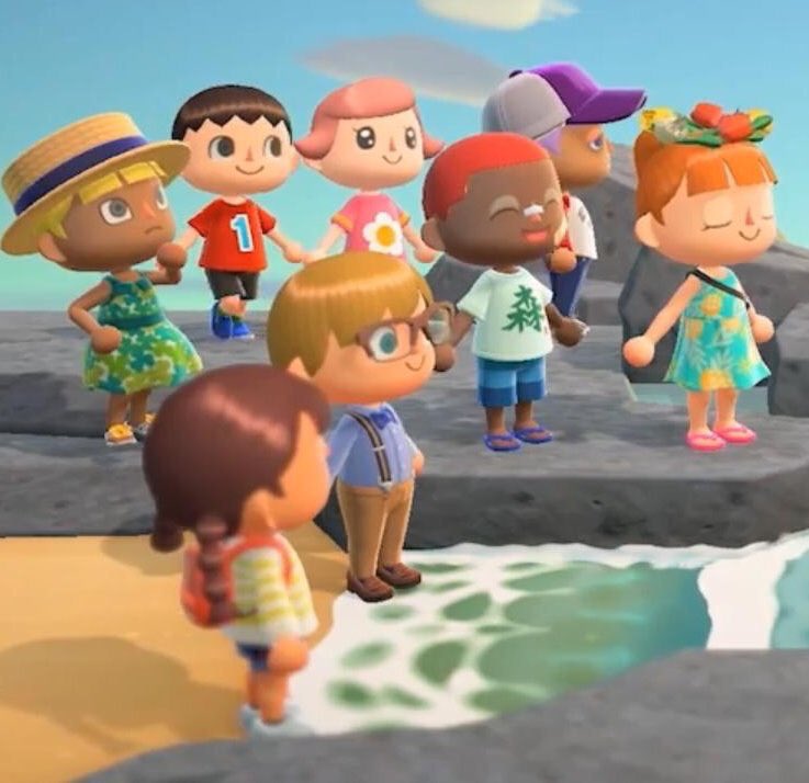 A group of animal crossing characters stood on the beach smiling