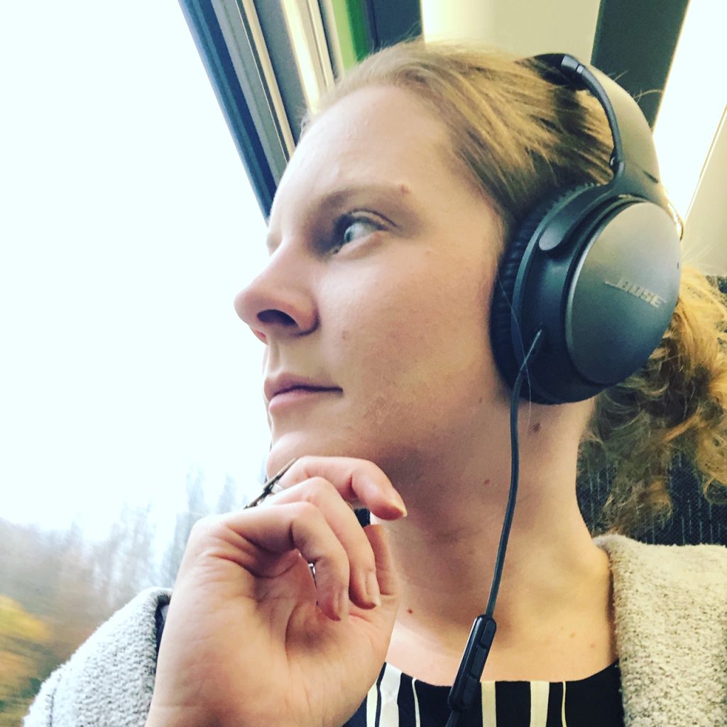 Hannah Rutherford looking out window wearing headphones